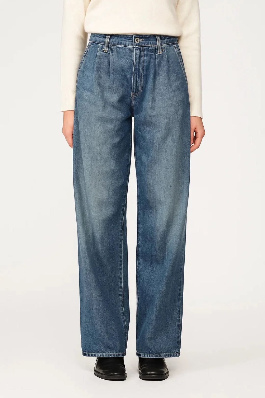 Women's wide leg jeans in light wash denim with high waist and relaxed fit worn with cream jumper