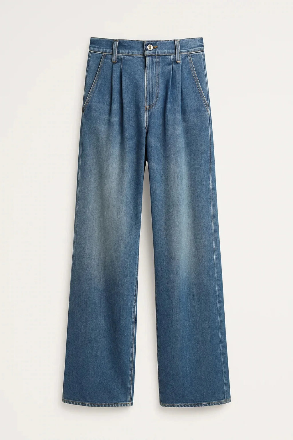 Close-up of women's wide leg jeans showing high waist pleated detail and light wash denim finish