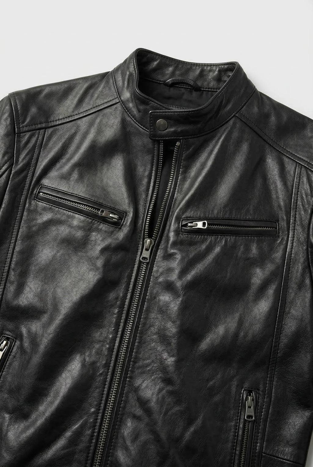 Close-up of men's biker jacket zip pocket detailing and smooth faux leather finish