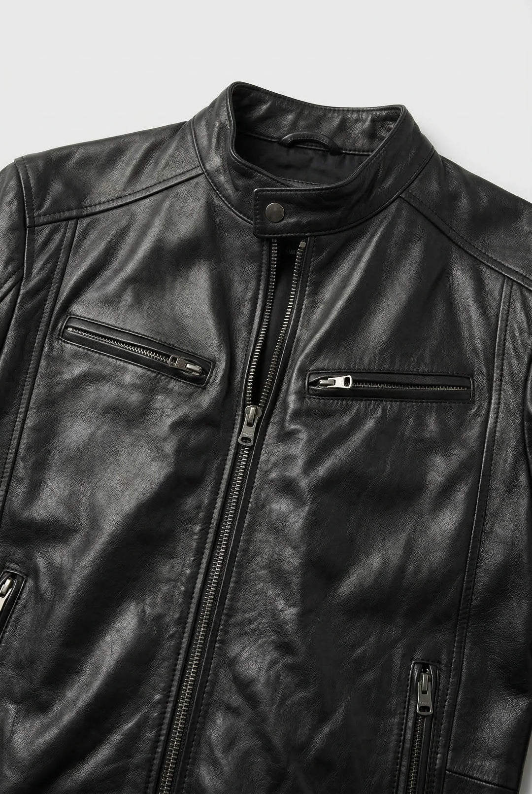 Close-up of men's biker jacket zip pocket detailing and smooth faux leather finish