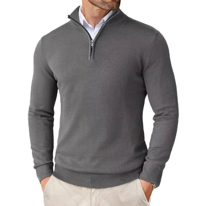 Close-up of quarter-zip collar detail on men's knit jumper showing ribbed trim and metal zip
