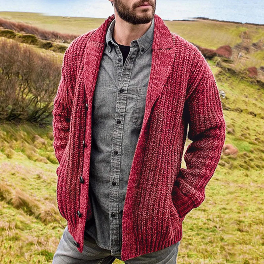 Man wearing a burgundy ribbed knit cardigan with shawl collar over a grey shirt in countryside setting
