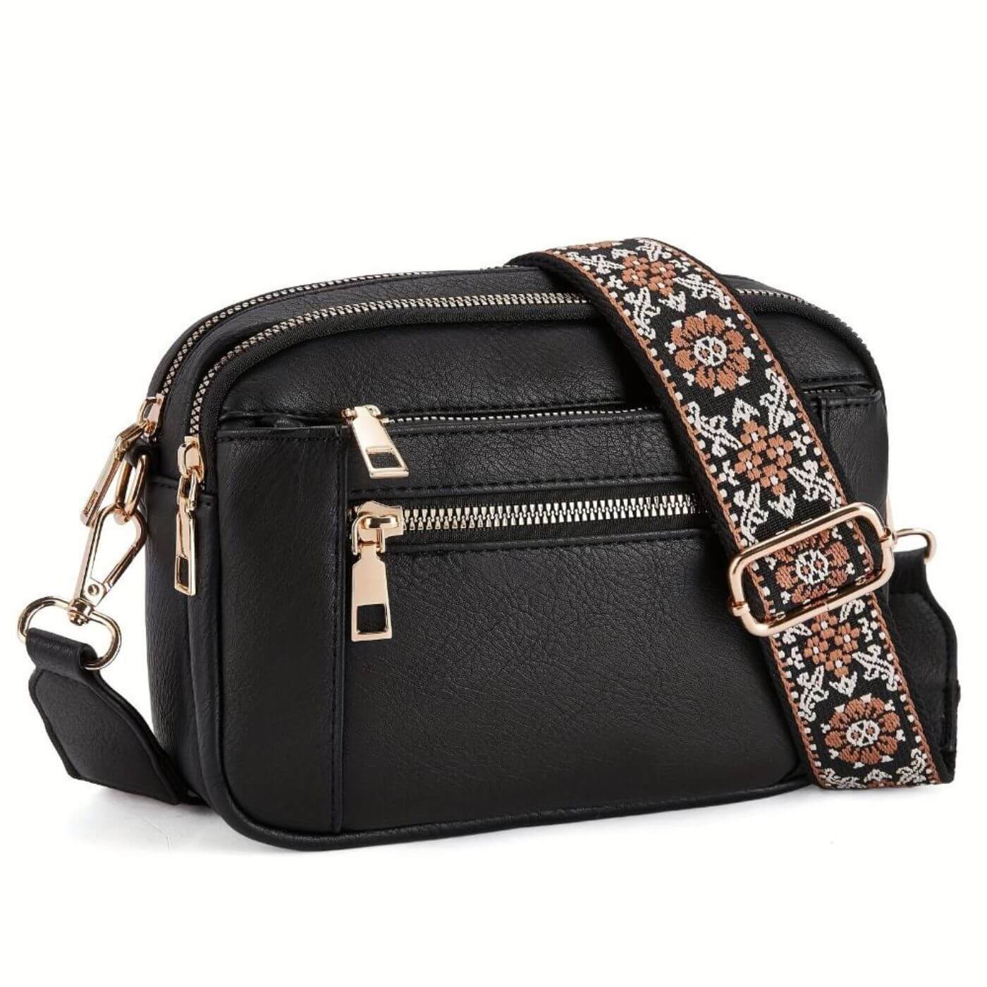 Close-up of embroidered strap with floral pattern and gold-tone hardware on crossbody bag