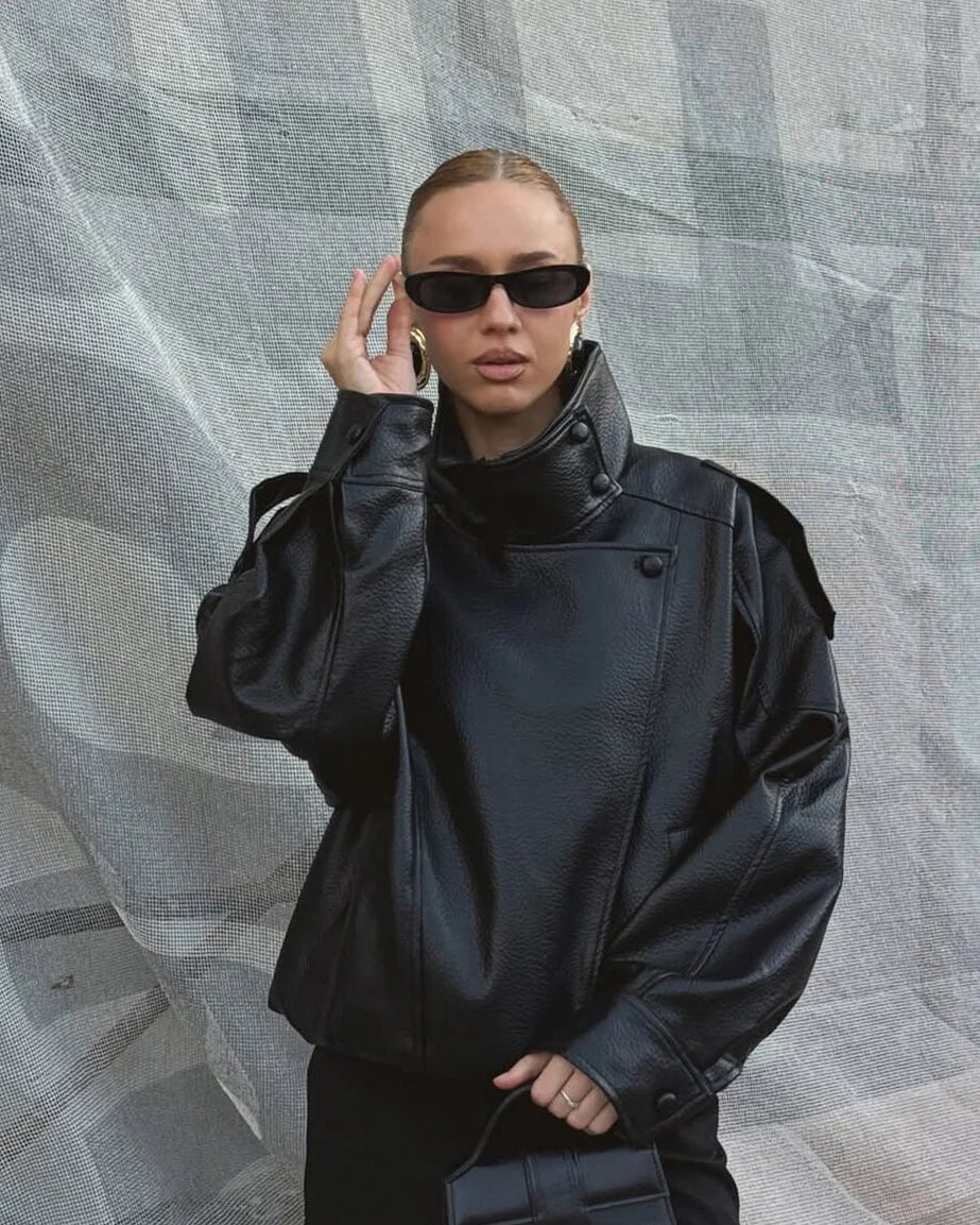 Side view of women's black bomber jacket with relaxed fit and dropped shoulders
