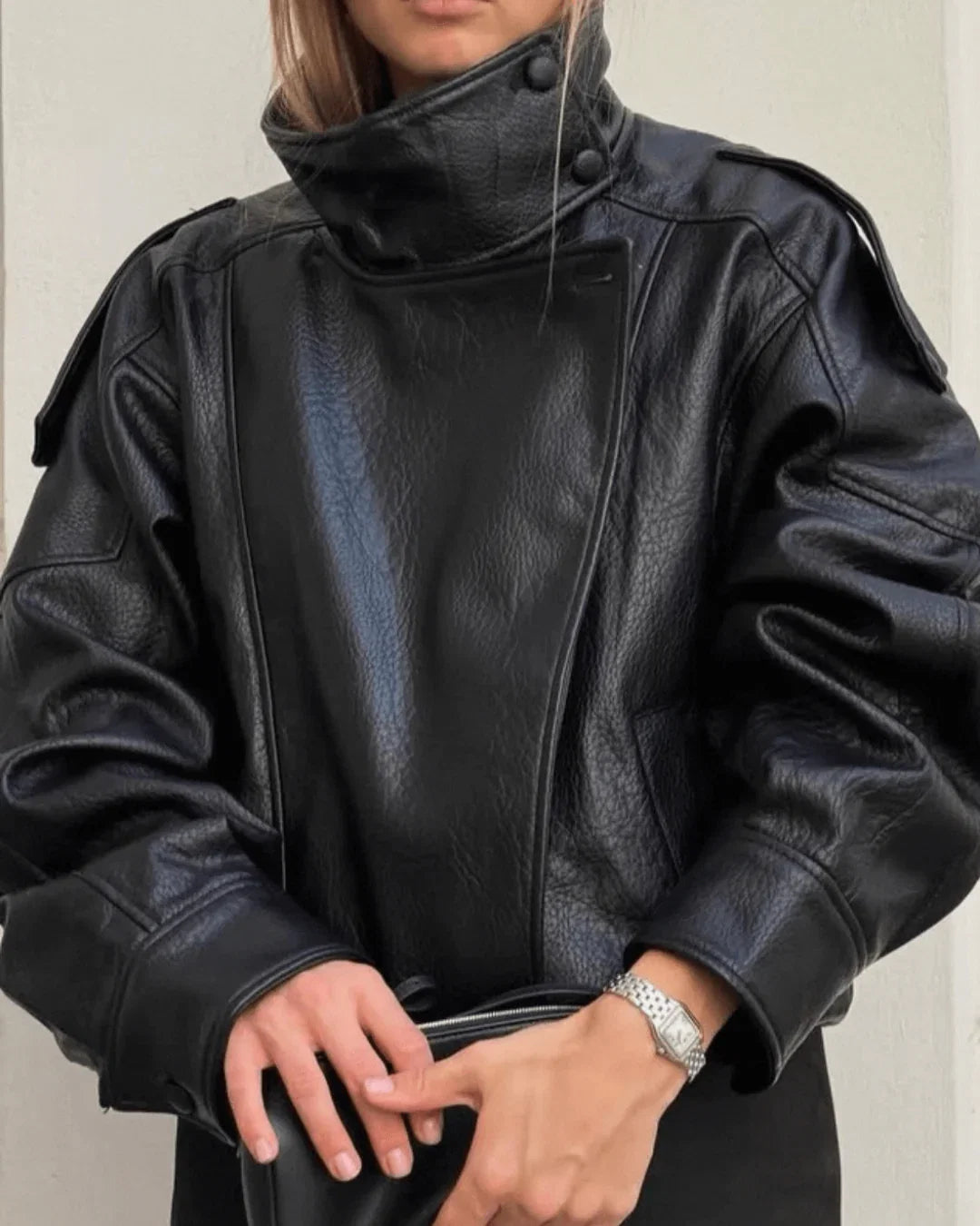 Back view of women's faux leather bomber jacket showing smooth finish and structured drape