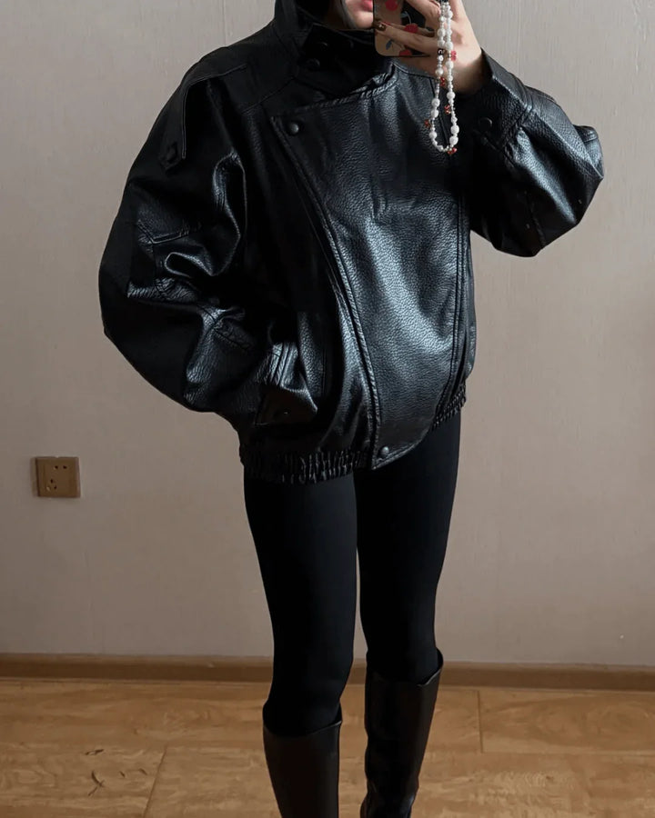 Women's black bomber jacket styled with casual outfit for transitional weather