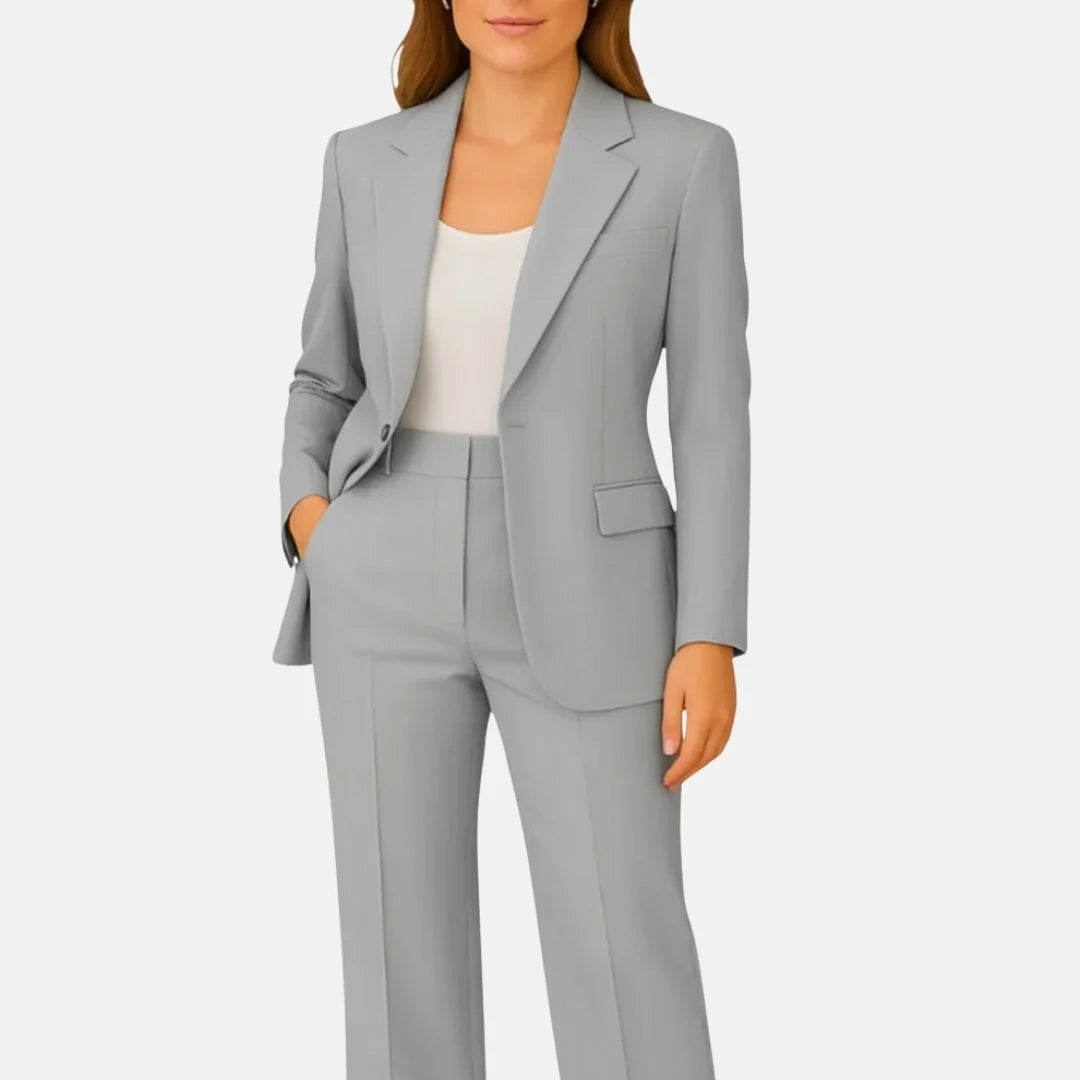 Wide-leg trousers with pressed centre crease and high waist paired with fitted blazer in beige