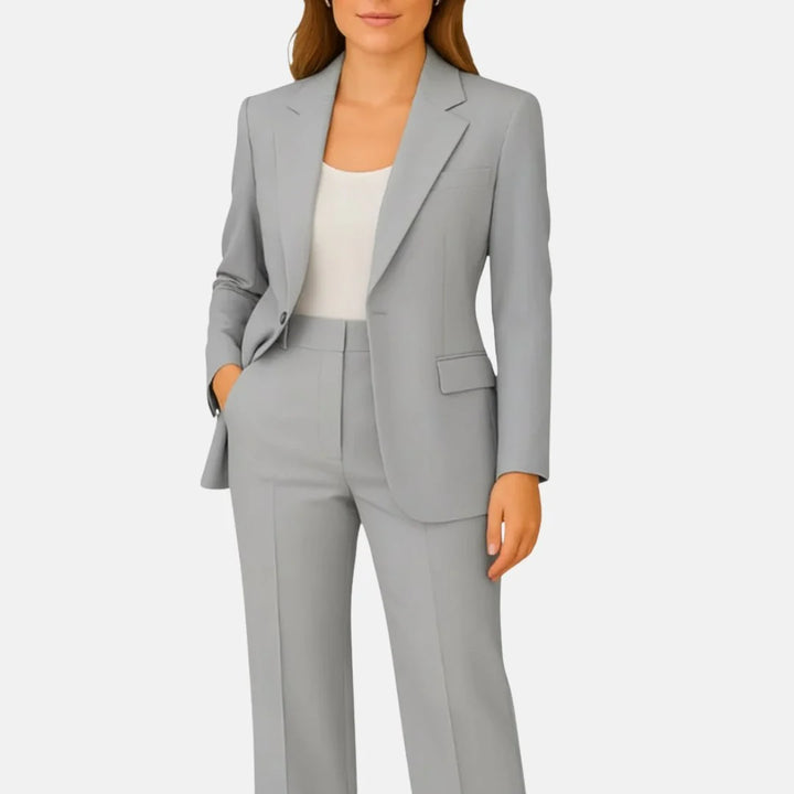 Wide-leg trousers with pressed centre crease and high waist paired with fitted blazer in beige