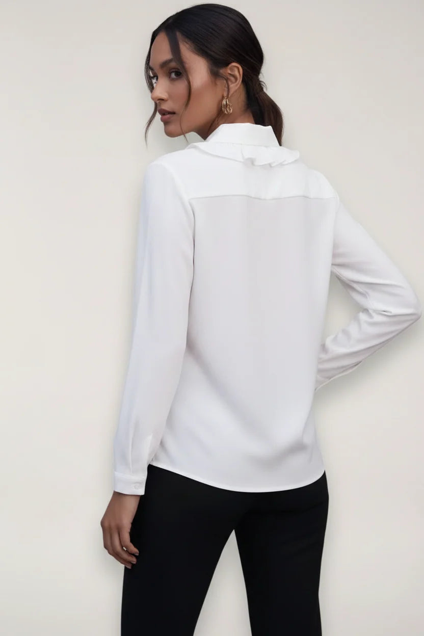 Close-up view of women's tailored blouse showing structured fabric and collar detail