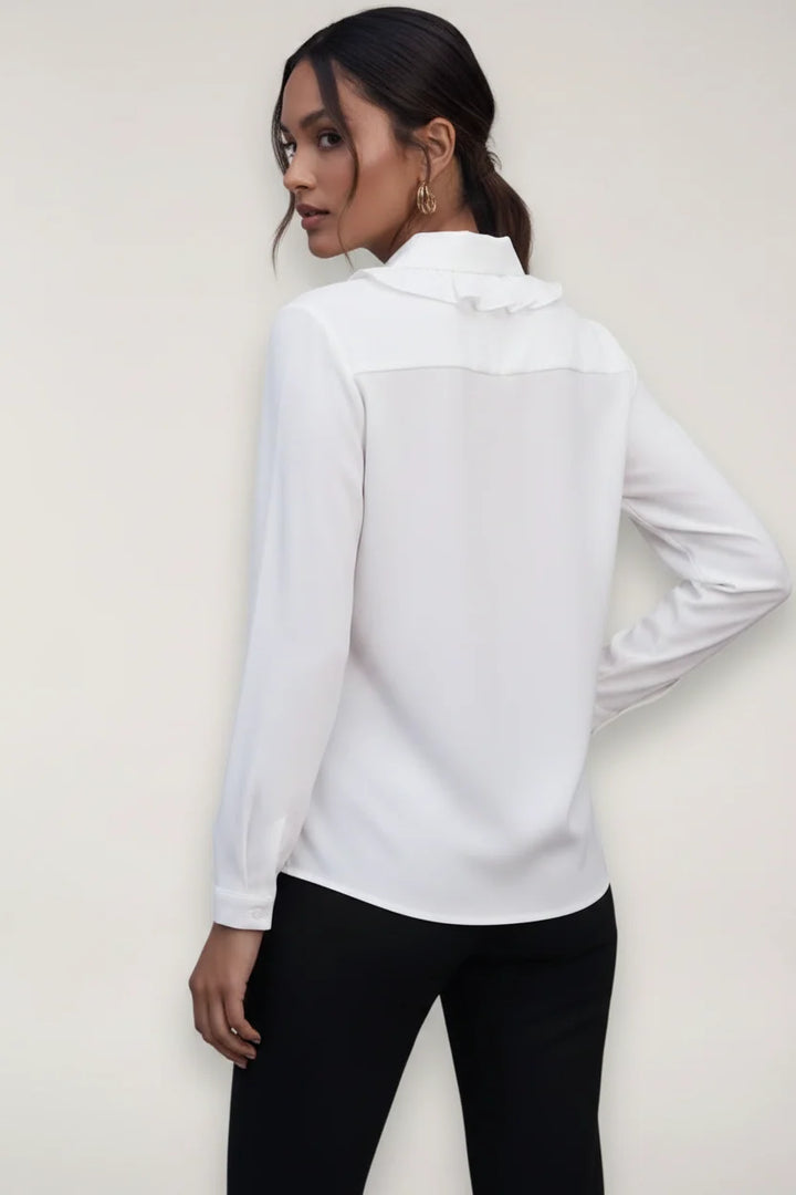 Close-up view of women's tailored blouse showing structured fabric and collar detail