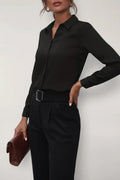 Side view of women's button-up blouse highlighting tailored waist shaping and long sleeves