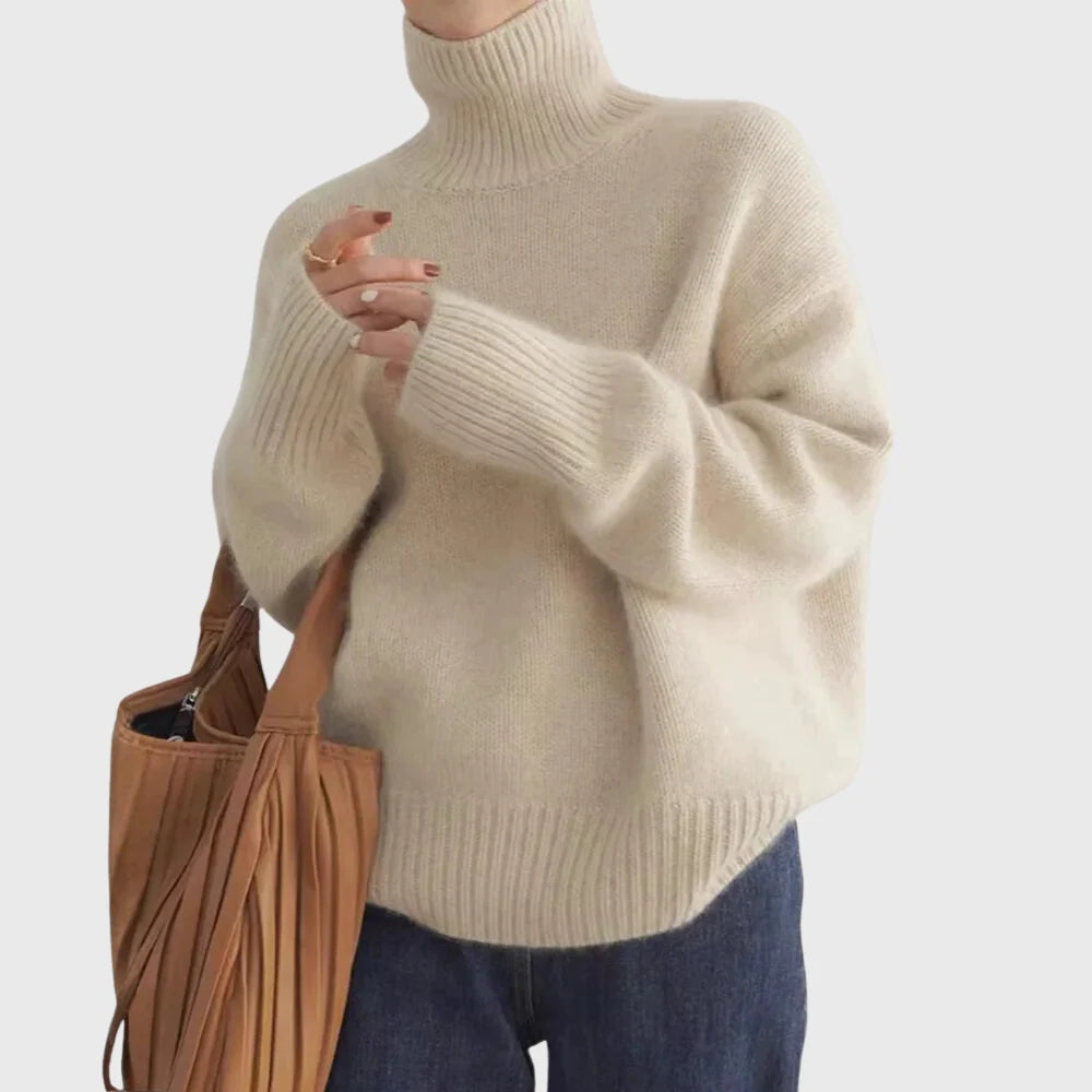 Close-up view of women's turtleneck jumper showing soft knit texture and high rolled neckline detail