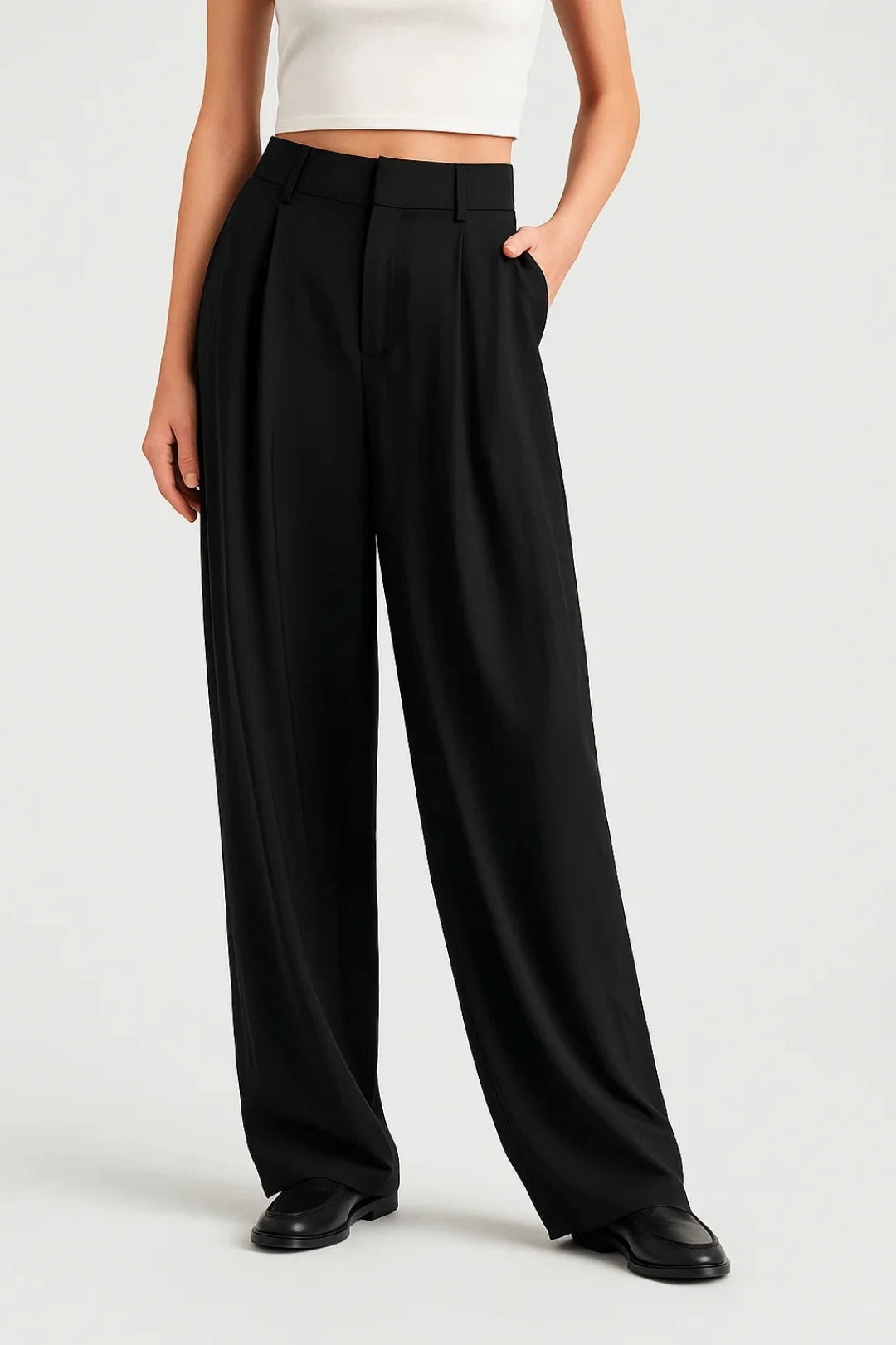 Women's wide leg trousers in black with high waist and pleated front detail worn with white crop top