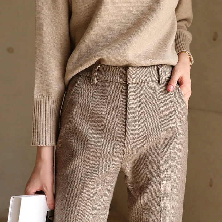 Close-up of wool trouser waistband showing high-waist design and front pleat detail