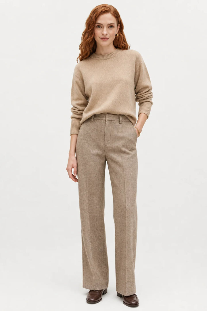 Woman styling wool trousers with oversized knitwear for a smart-casual autumn look