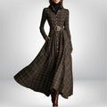 Close-up of plaid belted shirt dress showing collared neckline and long sleeves with button closure
