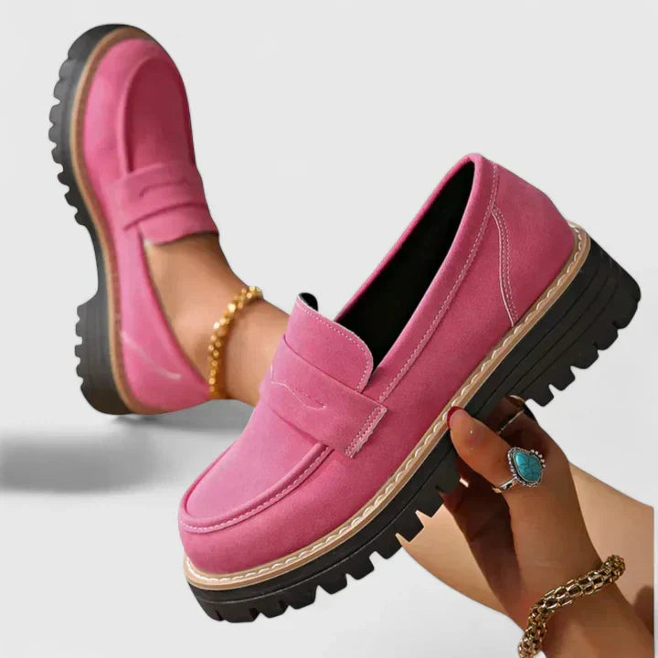 Close-up view of women's chunky loafers showing moc-toe stitching and contrast welt detail on deep tread sole