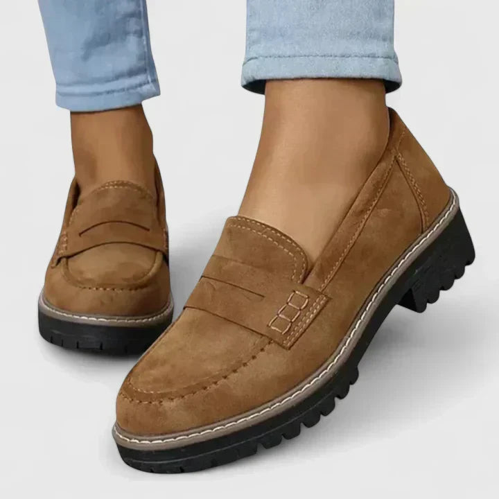 Rear view of women's chunky loafers highlighting deep tread rubber outsole and structured heel counter