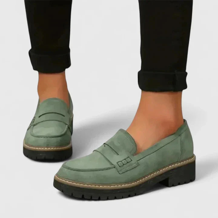 Women's chunky loafers styled with rolled denim showing slip-on design and supportive footbed construction