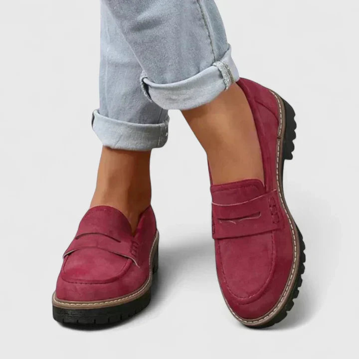 Detail shot of women's chunky loafers emphasising moc-toe stitching and classic penny strap loafer design
