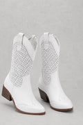 Women's cowboy boots in white with perforated detailing and block heel on neutral background
