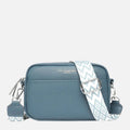Women's compact crossbody bag in teal with wide geometric-print strap and dual zip-top closure