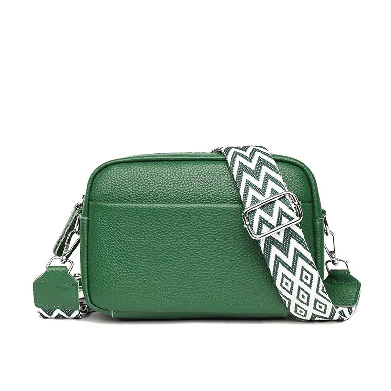 Structured boxy crossbody bag in teal with clean lines and decorative patterned strap detail