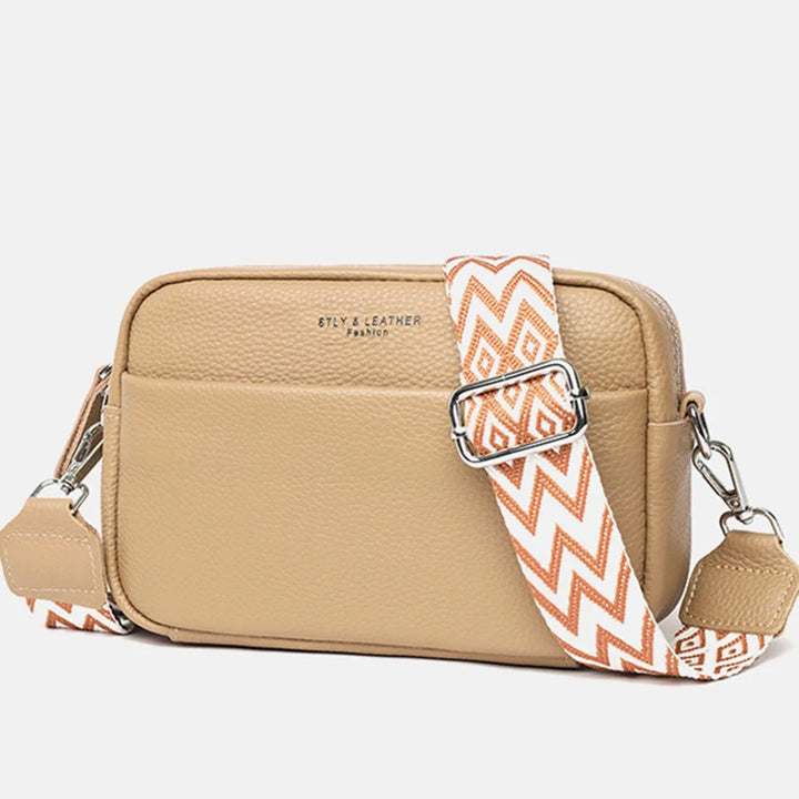 Textured finish crossbody bag showing adjustable strap and compact silhouette for everyday carry