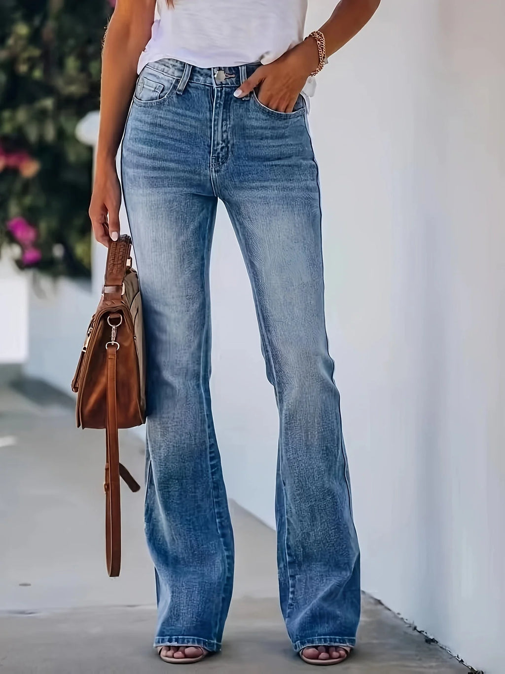Women's mid-rise flare jeans in faded denim with button-fly closure and retro-inspired silhouette