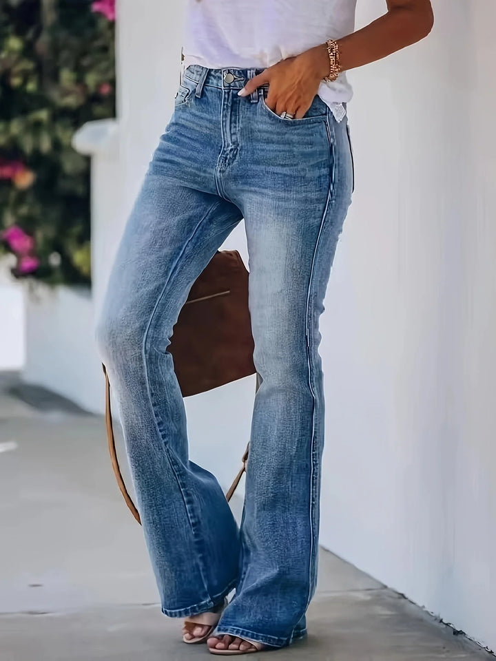 Detail shot of button-fly closure and five-pocket styling on mid-rise flare jeans