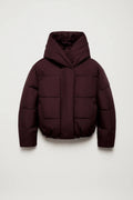 Women's oversized puffer jacket in burgundy with wide hood and cropped quilted design on neutral background