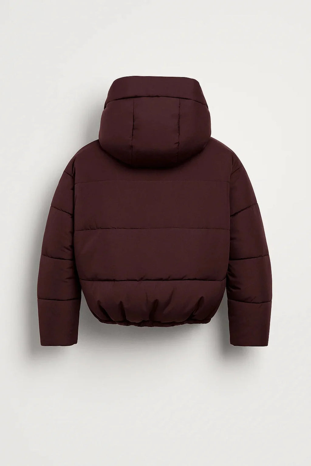 Front view of burgundy women's puffer jacket showing wide hood and horizontal quilted panels with elastic hem