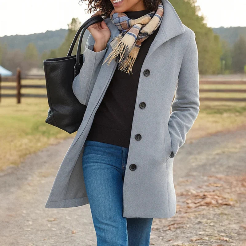 Woman wearing a grey women's tailored wool-blend coat with button-front closure and structured collar outdoors