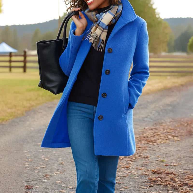 Close-up of women's tailored wool-blend coat fabric texture and button detail