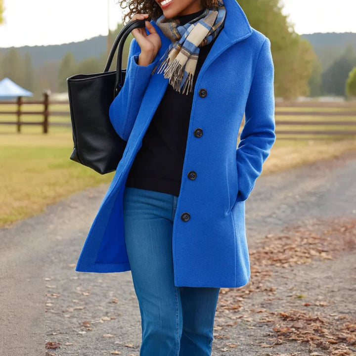 Close-up of women's tailored wool-blend coat fabric texture and button detail