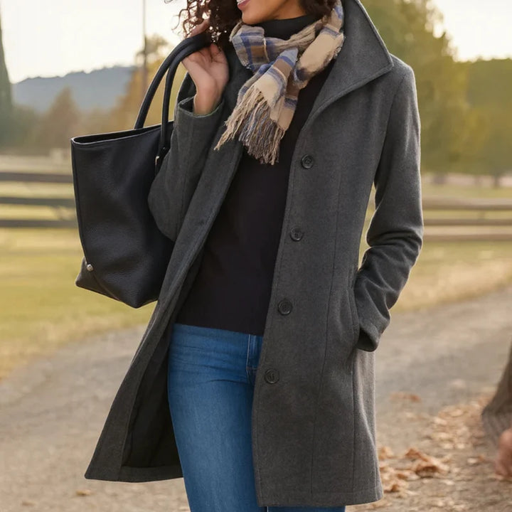Side view of woman in grey women's tailored wool-blend coat with functional side pockets