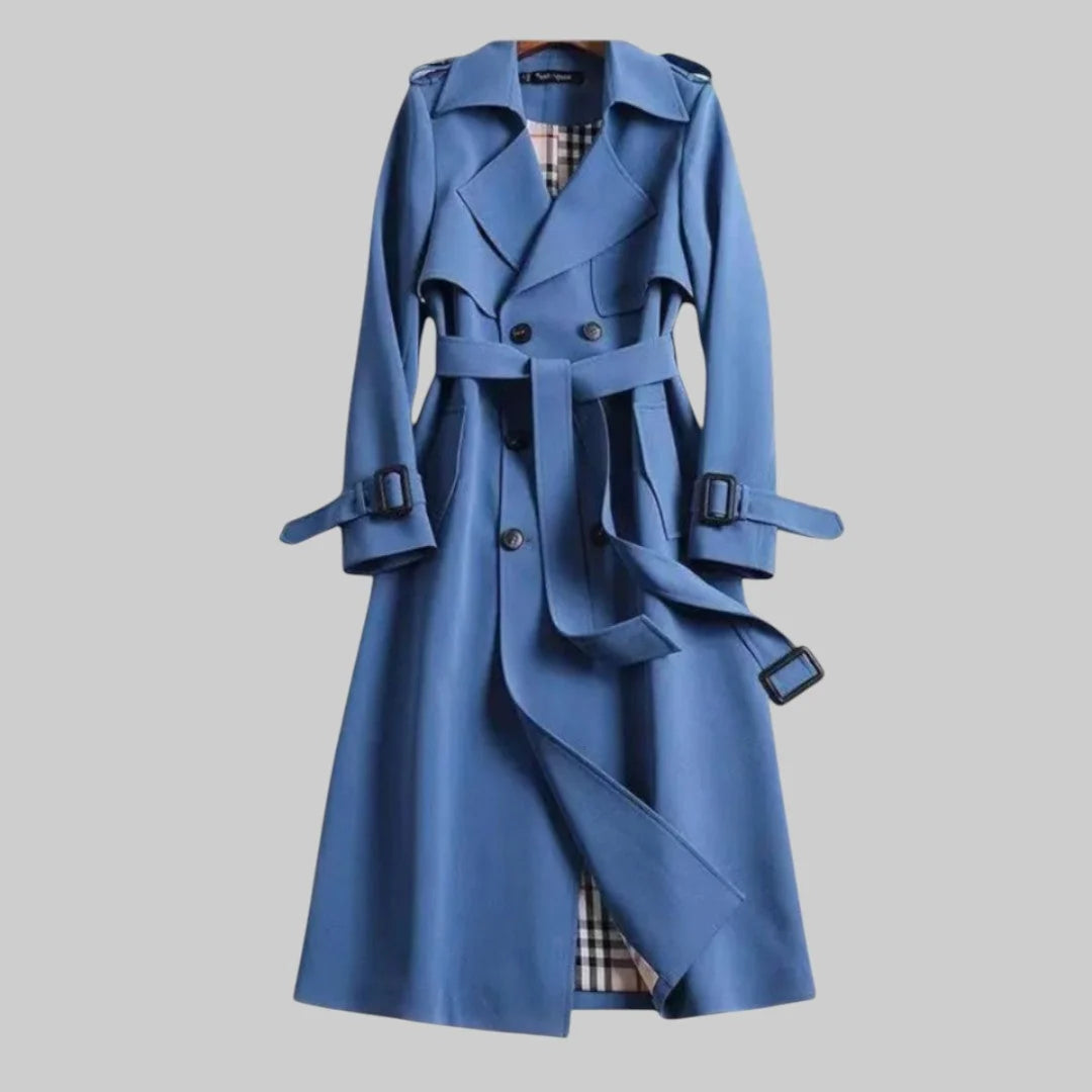 Women's trench coat displaying long length cut and overlapping front panel construction