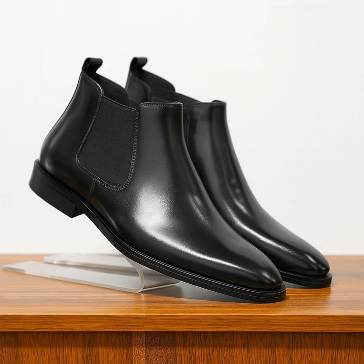 Close-up view of men's brown Chelsea boots showing smooth finish and pull tab detail
