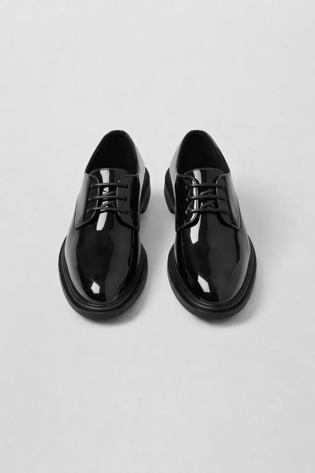 Men's derby shoes styled with tailored navy trousers for formal occasion