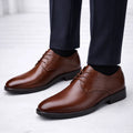 Men's formal derby shoes in brown with lace-up closure and smooth polished upper paired with tailored trousers