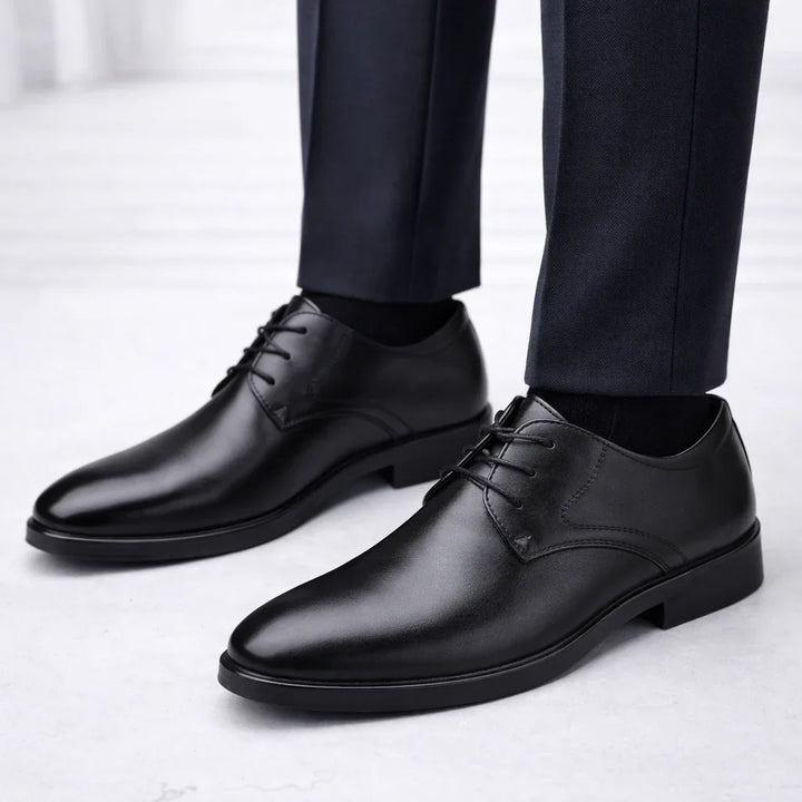 Close-up view of men's brown derby shoes showing classic lace-up design and stacked heel construction
