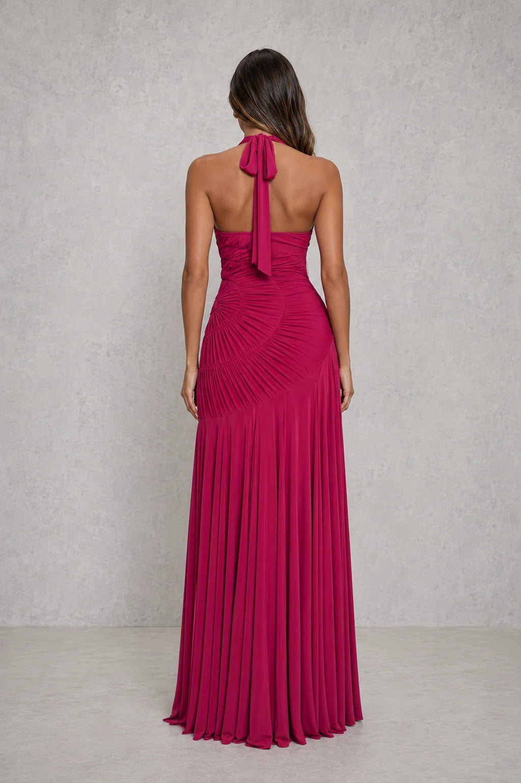 Side angle of halter neck maxi dress with flared godet hem and sculpted waist