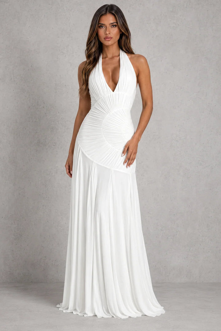 Full-length halter neck maxi dress in magenta showing graceful silhouette and movement