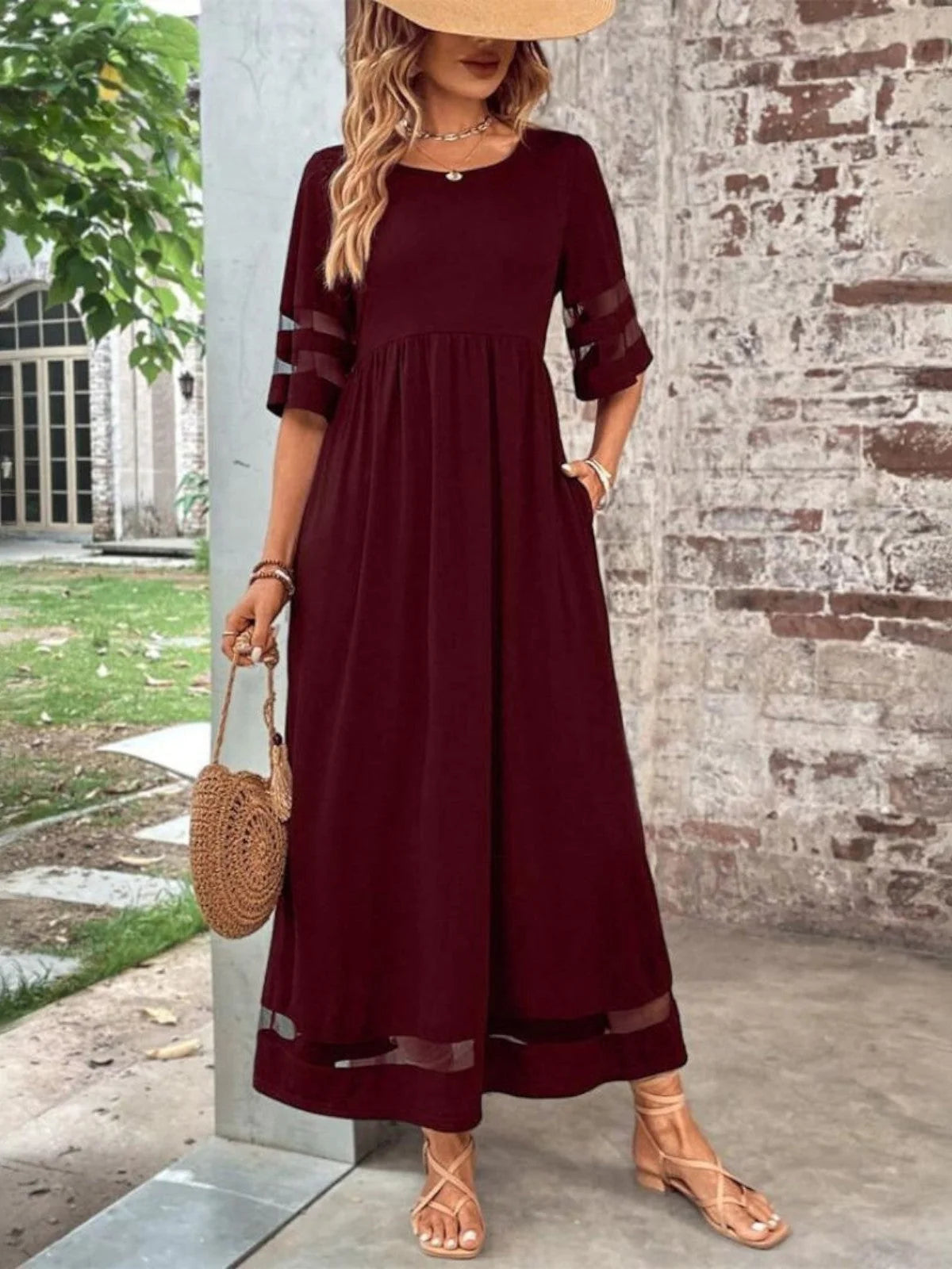 Close-up view of the mesh detail maxi dress showing the empire waist and flowing skirt silhouette