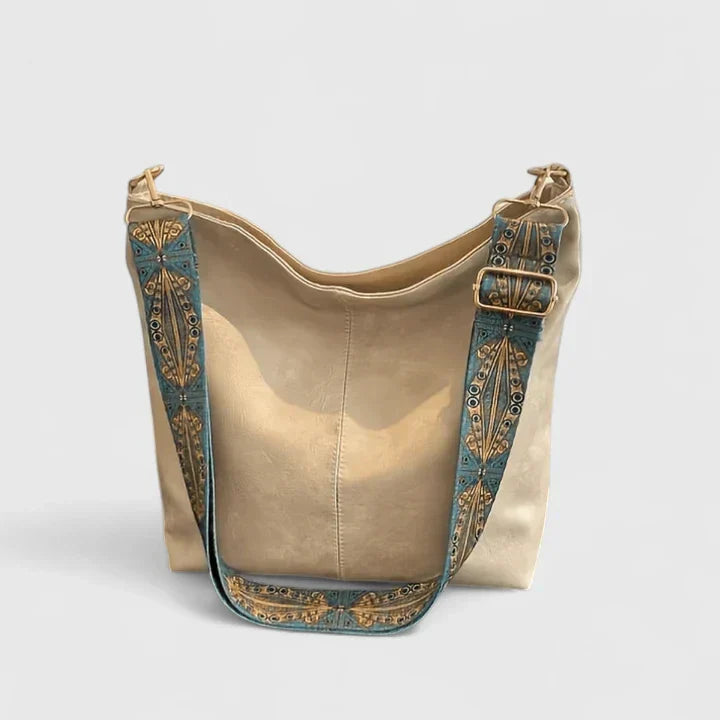 Women's bucket bag in beige with embellished wide strap and slouchy silhouette