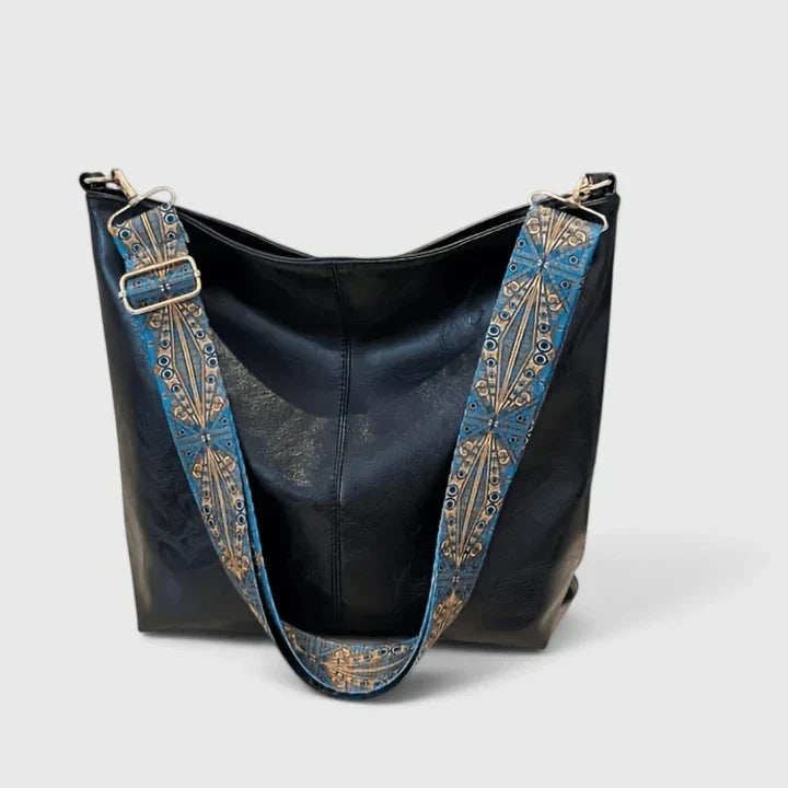 Spacious women's shoulder bag with vintage-inspired embellished strap and roomy interior