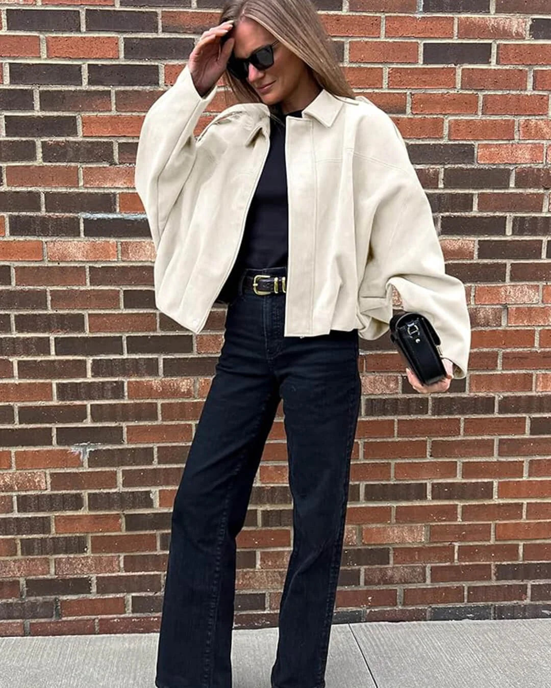 Women's collared bomber jacket modelled showing cropped length and flattering silhouette