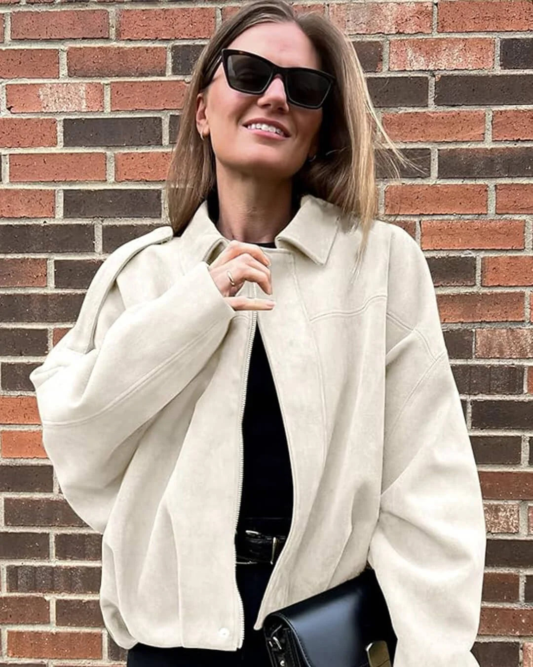 Full-length view of women's collared bomber jacket in olive green with elasticated details