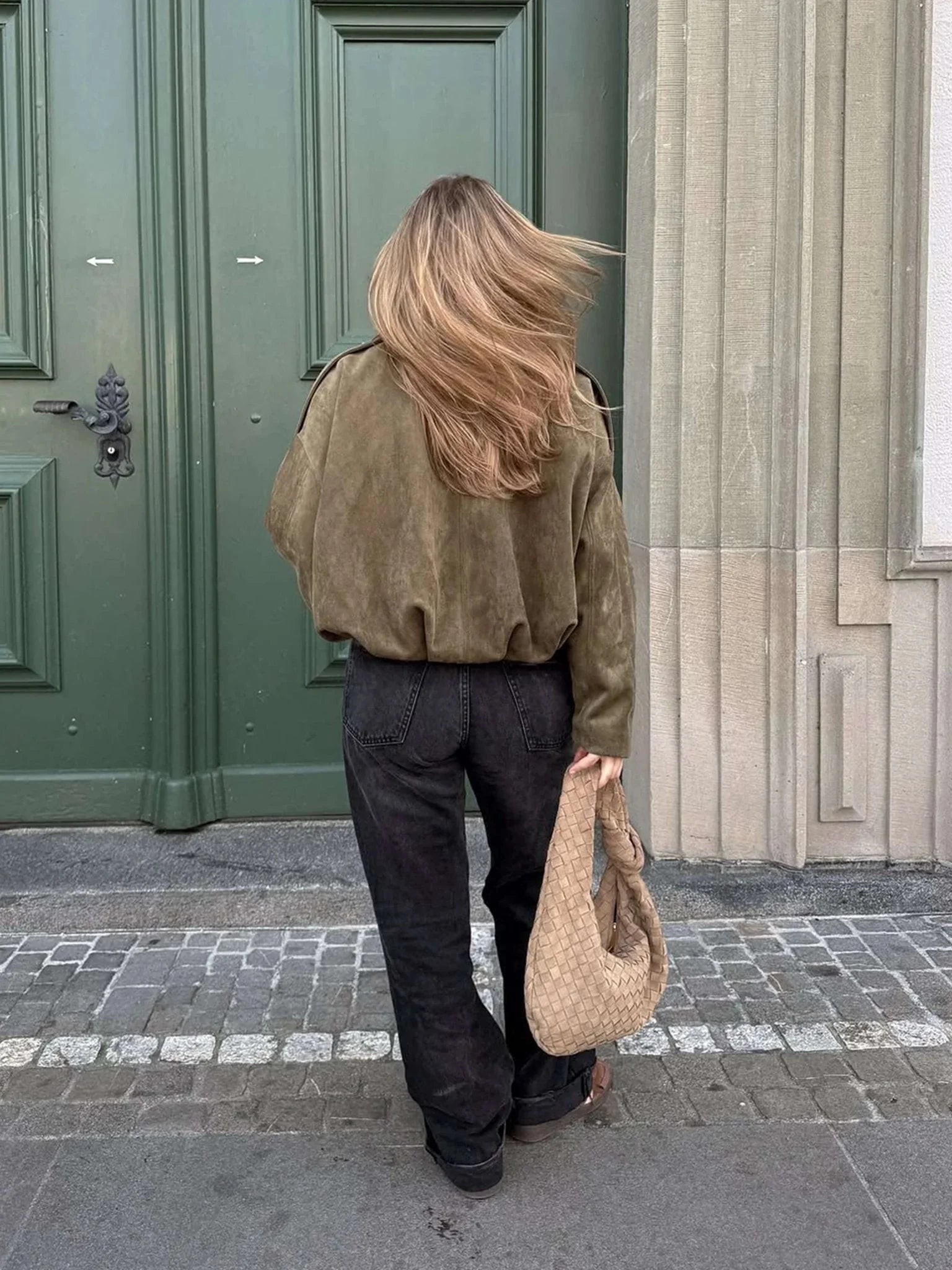 Back view of women's collared bomber jacket showing cropped length and relaxed silhouette