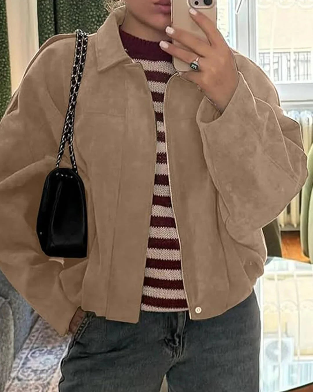 Front view of women's collared bomber jacket in olive green with concealed zip fastening